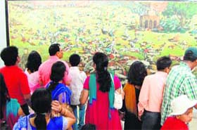 Visitors have a look at a picture of the martyrs of the Jallianwala Bagh massacre at the bagh in Amritsar on Thursday