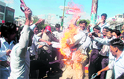 Striking workers of the Rockman industry burn an effigy of the factory management in Dehradun on Thursday