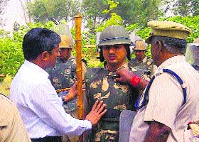 IGP Alok Mittal interacts with a policeman of the Reserve Police Force at Police Lines in Jhajjar
