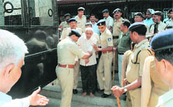 An elderly convict in the Ode riots case comes out of the court in Anand