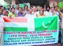 Members of the Pakistan-India Peoples Forum for Peace and Democracy hold a candlelight march on the anniversary of the Jallianwala Bagh massacre in Amritsar on Friday.