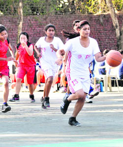 A match in progress in the District Junior Basketball Championship for girls in Dehradun on Friday. 