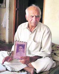 Suraj Bhan with a photograph of his brother, Madan Lal, lodged in a Pakistan jail