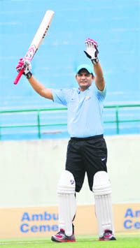 Former Indian cricket team captain and MP Mohammad Azharuddin celebrates his century at the Dharamsala cricket stadium.