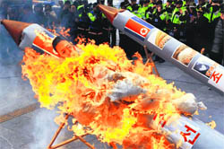 Activists in South Korea set fire to a mock North Korean missile carrying an effigy of North Korean leader Kim Jong-Un during a protest in Seoul