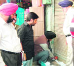 Officials of the house tax department seal a shop in Amritsar in March