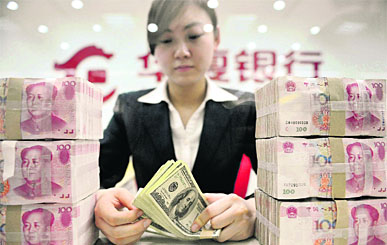 An employee counts US dollar banknotes at a branch of Huaxia Bank in Shenyang, Liaoning province. China took a milestone step in turning the yuan into a global currency on Saturday by doubling the size of its trading band against the dollar, pushing through a crucial reform that further liberalizes its nascent financial markets. 