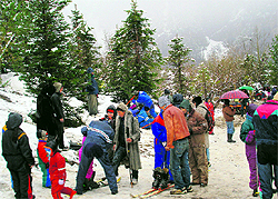 Tourists enjoy fresh snowfall near Gulaba on the Manali-Rohtang Pass road on Saturday
