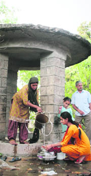 Women fetch water from a well at Suriansar village in Jammu.