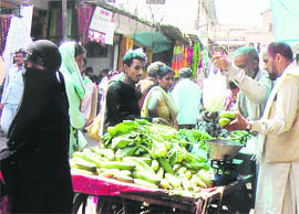 Vegetable sellers using polythene bags in a market in Poonch. 