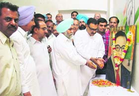 District Congress president (urban) Pawan Dhiwan and rural Congress president Malkeet Singh Dakha pay tributes to Dr BR Ambedkar at the Congress Bhawan in Ludhiana on Saturday