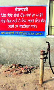 A notice warning handpump water unfit for consumption put up by the Water Supply and Sanitation Department at Teja Rohela village in Fazilka. 