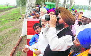 A devotee having darshan through binoculars