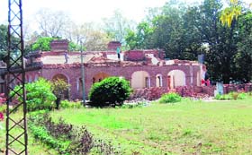 Labourers demolish the bungalow in Amritsar