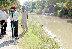 Officials of the Irrigation Department conducting a survey along the canal in Bathinda