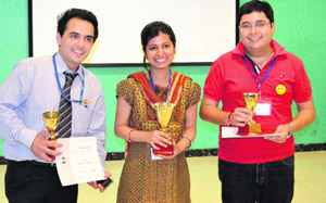 Winners of International Speech and Table Topic Contest pose with their trophies. A Tribune photograph