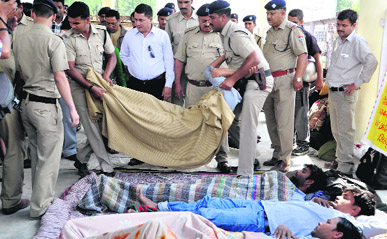 Policemen forcibly take away fasting employees of Rockman and Satyam companies to hospital from the Parade Ground in Dehradun on Sunday.