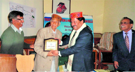 An angler gets a prize after an angling competition at Sai Ropa in Kullu on Sunday.