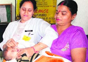 A health worker gives polio drops to an infant at Government District Hospital in Reasi on Sunday