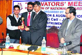 A young innovator being felicitated at Kashmir University in Srinagar