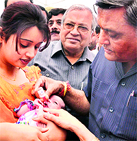 BJP MLA Manoranjan Kalia with Health Minister Madan Mohan Mittal administers polio drops to a child during the Pulse Polio drive in Jalandhar on Sunday