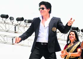 Bollywood actor Shah Rukh Khan (L) performs at the inauguration of a film city near Kolkata on Sunday