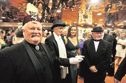 Passengers, in costumes and evening dress, walk around the MS Balmoral Titanic memorial cruise ship, prior to a gala dinner in the Atlantic Ocean on Friday. Nearly 100 years after the Titanic went down, the cruise with the same number of passengers aboard has set sail to retrace the ships voyage, including a visit to the location where it sank.