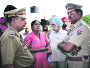 Police officials interact with the family members of deceased Ravinder Kaur in Amritsar on Monday.