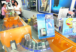 Nokia mobile phones are displayed for sale near Samsung and Nokia's advertisements at a shop in Hanoi. Samsung Electronics will overtake Nokia as the worlds no. 1 cellphone manufacturer in a slowing global handset market, a Reuters poll of banks, brokerages and research firms showed