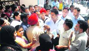 Parents of schoolchildren of Shri Guru Ram Rai hold a protest against fee hike in Dehradun on Monday.