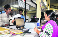 An employee of the Regional Transport Authority wears a black band on her arm in Dehradun