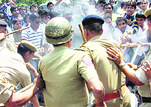 Policemen and members of the INSO clash during a demonstration in protest against corruption in MDU, Rohtak, on Monday. 