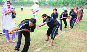 Girls participate in tug of war at a sports meet in Gurgaon.