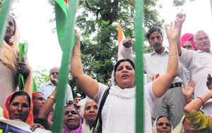 Members of the J&K Refugees Front protest in support of their demands in Jammu on Monday. 