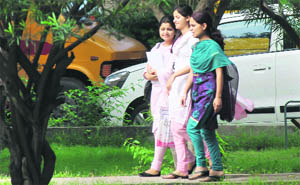 Girls enjoy a pleasant weather on the University of Jammu campus on Monday. 