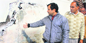 A resident of Dilbagh Nagar Extension Colony shows cracks in his house in Jalandhar.