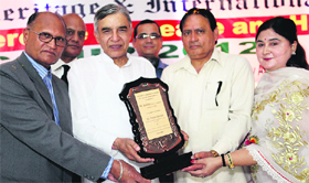 Pawan Bansal being given a peace award by Managing Director of the St Soldier Group of Institutions Anil Chopra in Jalandhar on Monday.