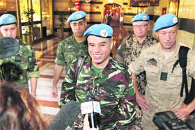 TOUGH TASK AHEAD: Ahmed Hommich (C), a member of the UN monitor team, speaks to the media at a hotel in Damascus on Monday