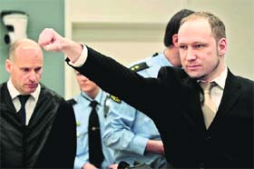 NO REMORSE: Accused Norwegian Anders Behring Breivik gives a clenched-fist salute as he arrives at the courtroom in Oslo on Monday