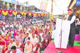 Chief Minister PK Dhumal addresses a public meeting at Baldwara in Mandi district on Tuesday