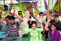 Members of the J&K Home Guards Welfare Association stage a protest in Jammu on Tuesday