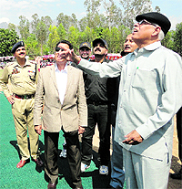 Governor NN Vhora flips a coin during the inauguration of the second phase of the Jammu Premier League T20 Tournament at Sports Stadium in Reasi on Tuesday