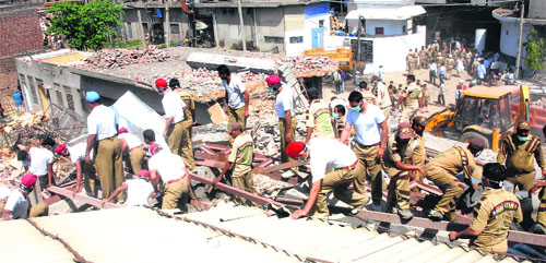 Volunteers of religious organisations and NGOs carry out rescue operation at the factory site in Jalandhar on Tuesday. 