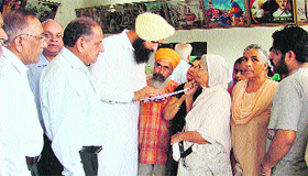 Ahead of the municipal elections, Akali councillor Tanvir Singh Dhaliwal redresses problems of elderly during a Lok Suvidha Camp in Shaheed Karnail Singh Nagar at Ludhiana on Tuesday.