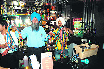Health department officials with the hookahs seized from a restaurant in Amritsar on Wednesday. 