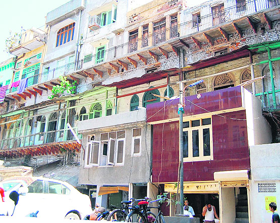 School children take part in a walk held to mark World Heritage Day; and (top) part of the old facade of Quila Ahluwalia near the Golden Temple has been replaced with a new design.