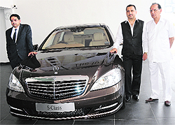 Debashis Mitra (L), director, sales and marketing, Mercedes-Benz India, and Sanjeev Dahuja (2nd from right), MD, Berkeley Motors, pose with a car at the inauguration of the companys first showroom in Haryana except NCR region, in Karnal on Wednesday