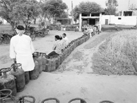 Customers wait for their turn at the LPG distribution centre at Lalru.