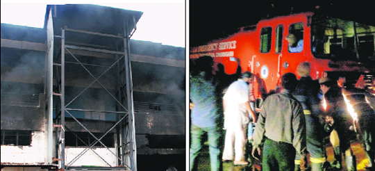 The broken wall of the warehouse that firemen broke to control fire; and (right) people push a fire brigade as it stopped working at Pabhat village near Zirakpur on Wednesday. 