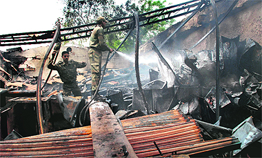Firemen try to douse flames on Wednesday. Tribune